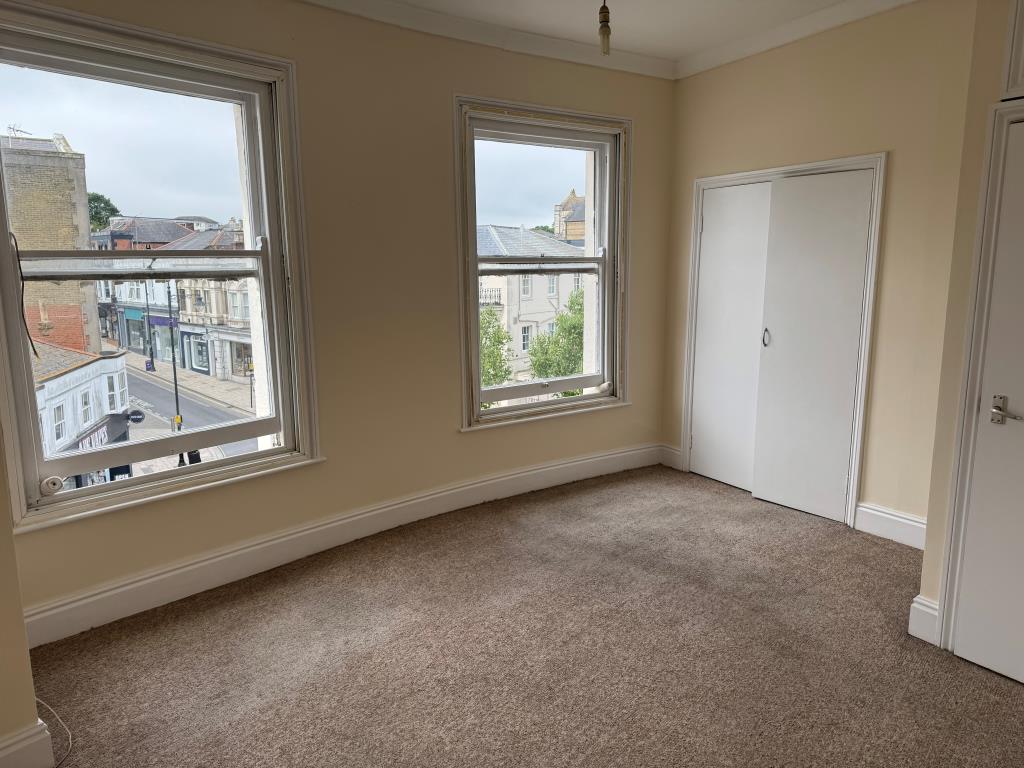 Lot: 59 - TOWN CENTRE FLAT FOR INVESTMENT OR OCCUPATION - The Bedroom and the View up High Street